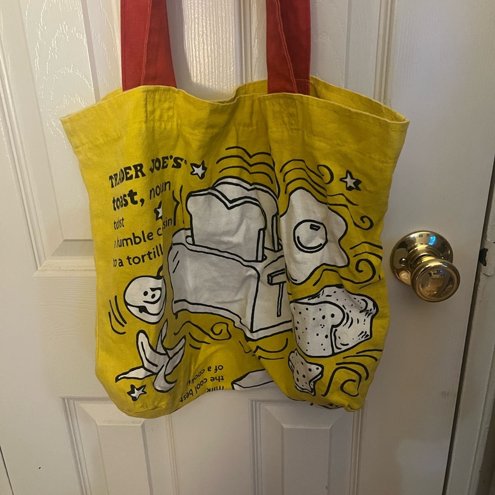 Trader Joe’s yellow tote with red handles.